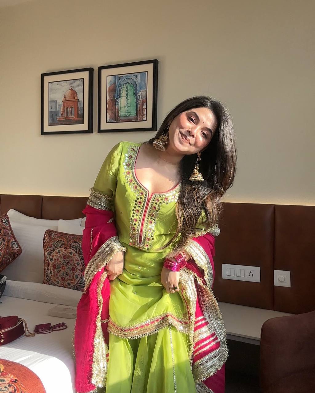 Vibrant lime green traditional outfit with pink and gold accents.