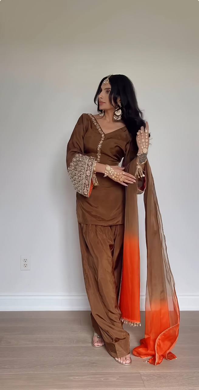 Elegant Brown Traditional Outfit with Orange Dupatta, Embellished Sleeves, and Gold Jewelry Ensemble